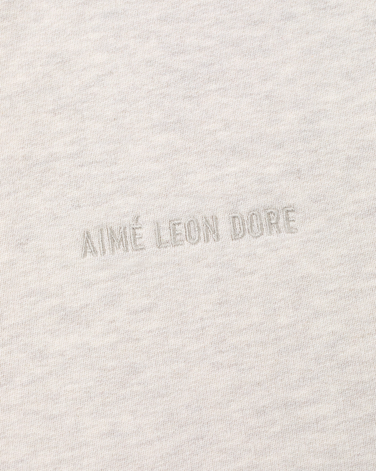 Close-up of the Tonal Logo Crewneck Sweatshirt with AIMÉ LEON DORE embroidered in matching thread at the center.