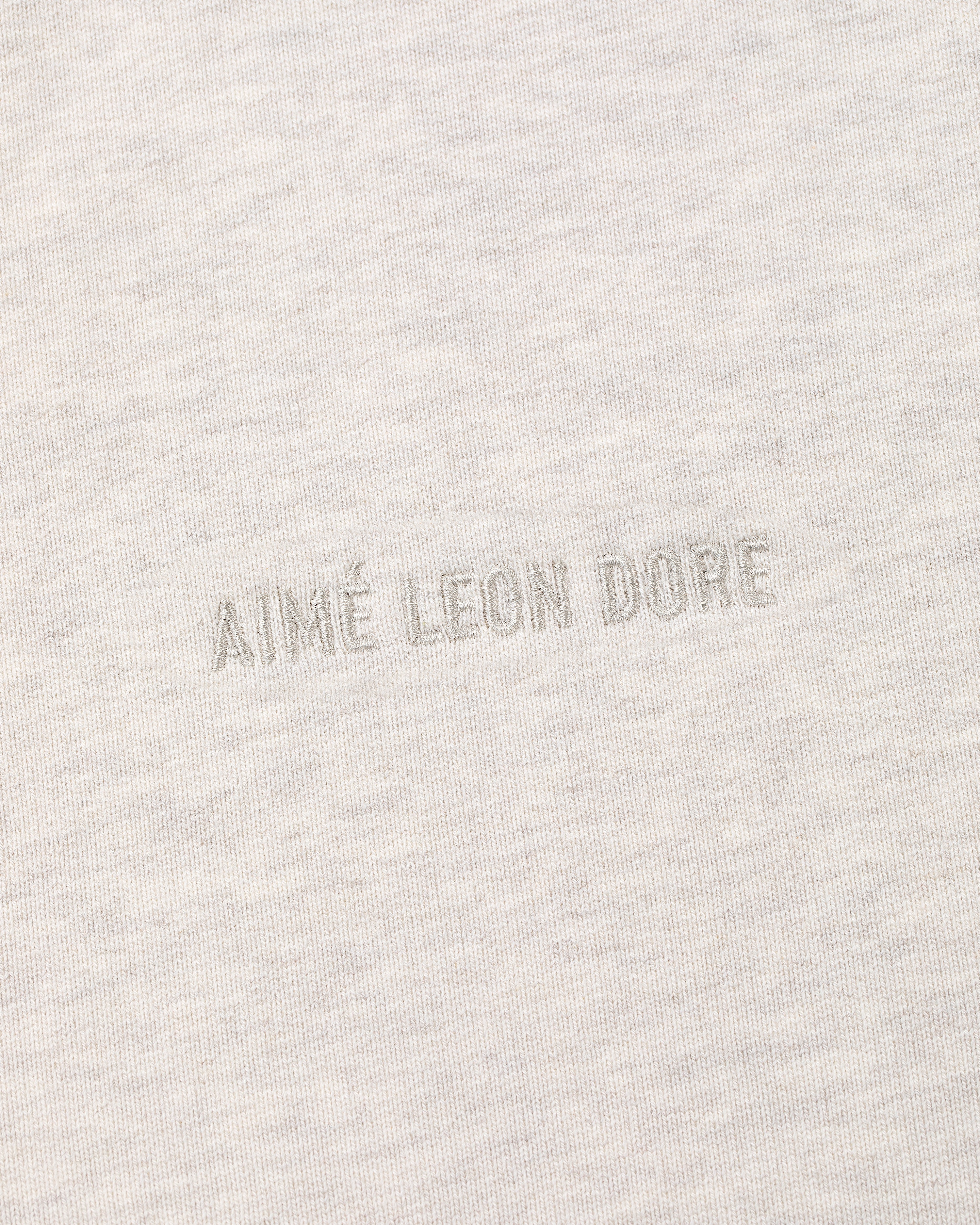 Close-up of the Tonal Logo Crewneck Sweatshirt with AIMÉ LEON DORE embroidered in matching thread at the center.