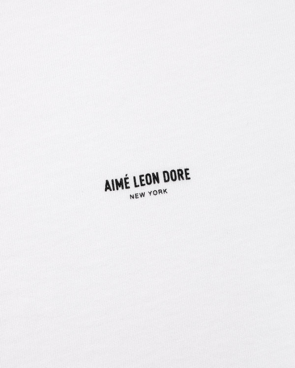 White Micro Logo Tee with black AIMÉ LEON DORE NEW YORK text printed at the center.