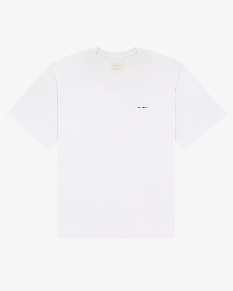 Micro Logo Tee: plain white short-sleeve t-shirt with a small black logo on the left chest.