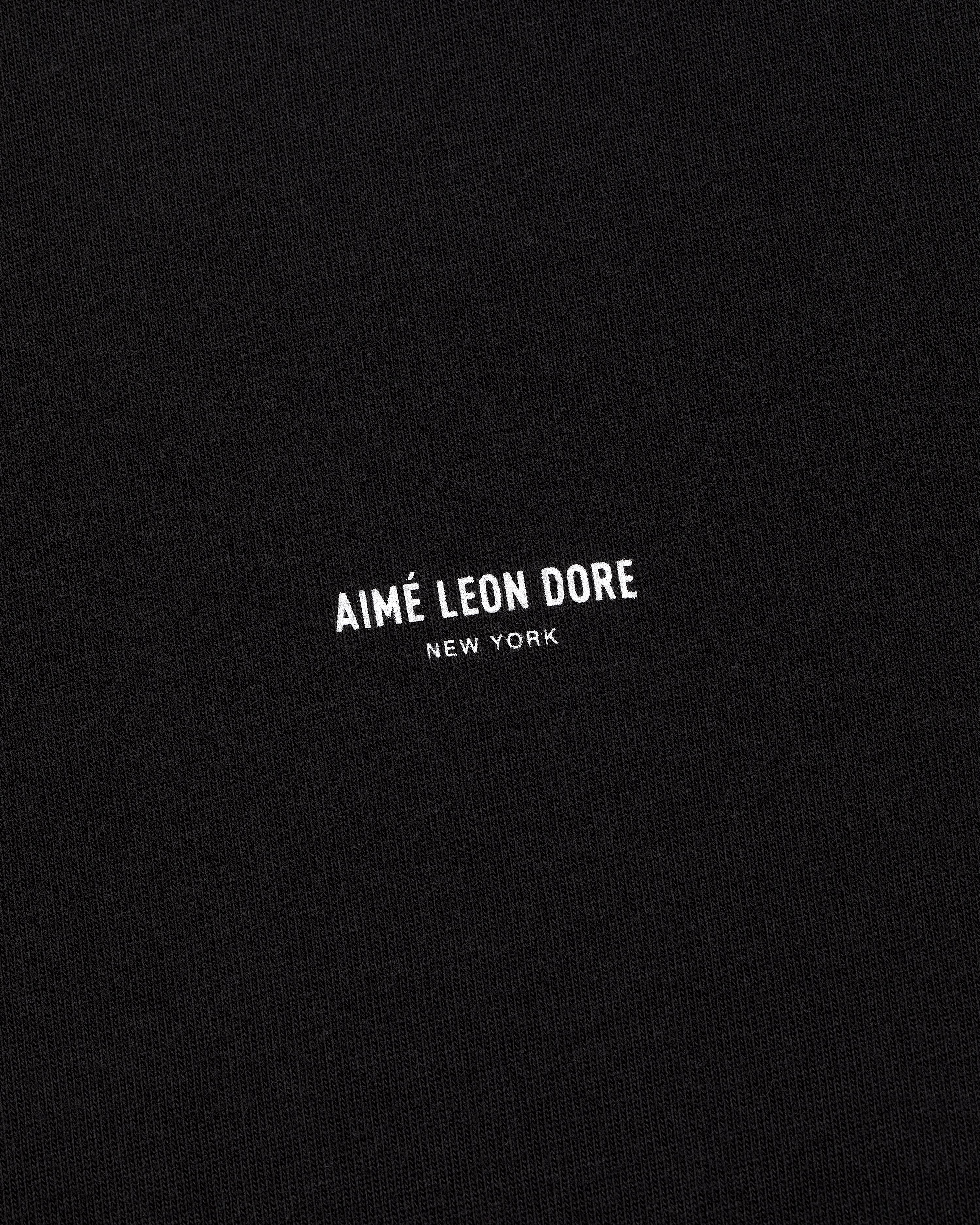 Black Micro Logo Tee with small white AIMÉ LEON DORE NEW YORK text in the center.