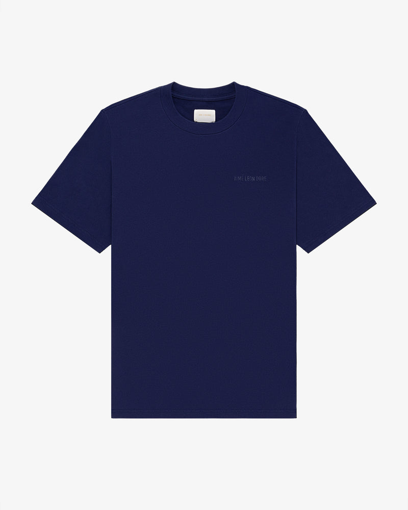 Navy Tonal Logo Tee, short sleeves, with a small white label inside the collar.