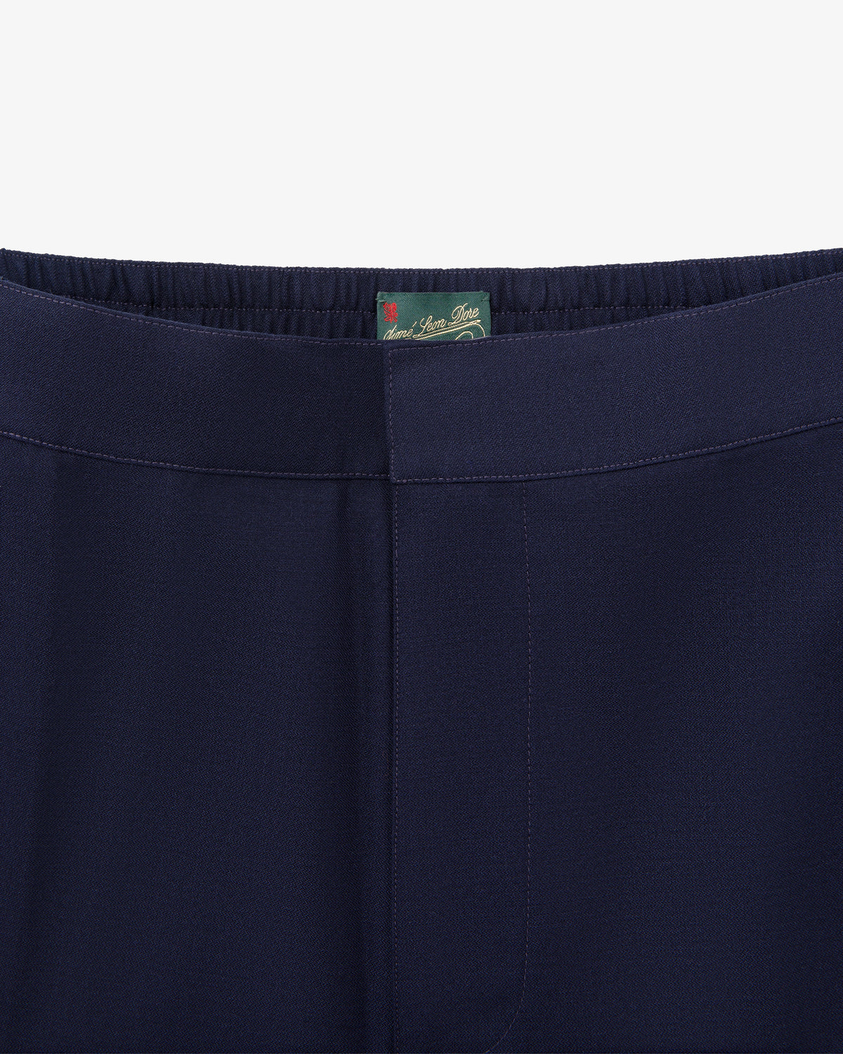 Close-up of waistband and upper part of Tropical Wool Elasticated Waist Suit Trouser in navy with a green inner tag.