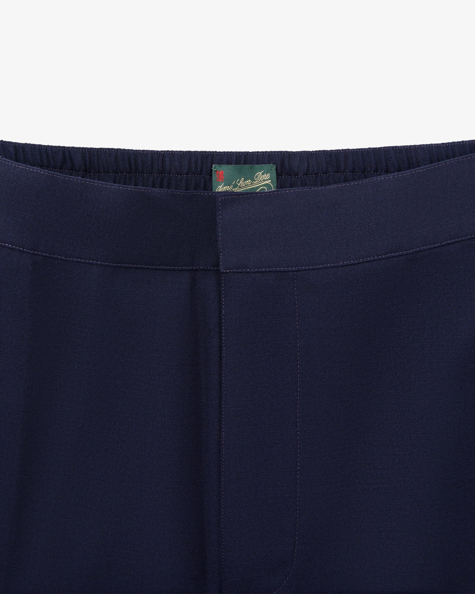 Close-up of waistband and upper part of Tropical Wool Elasticated Waist Suit Trouser in navy with a green inner tag.