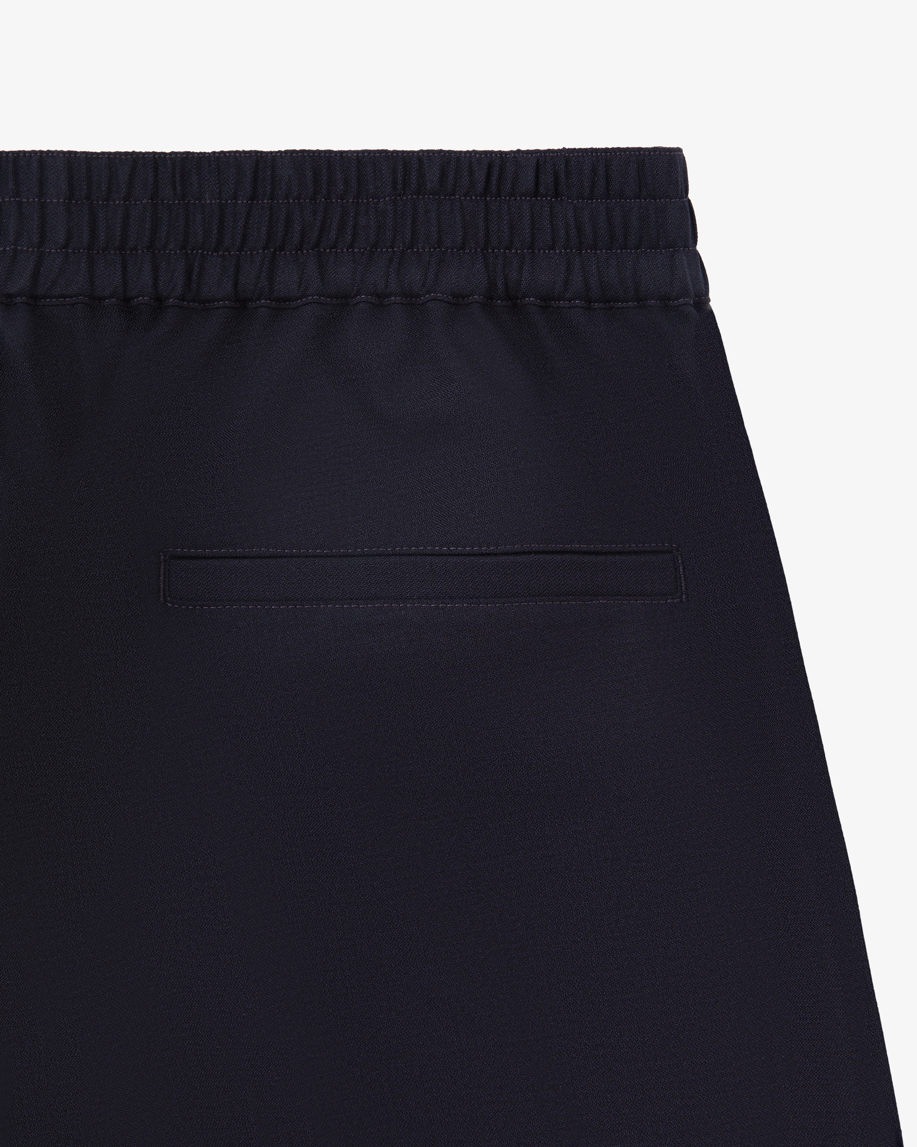 Close-up of the back of Tropical Wool Elasticated Waist Suit Trouser with an elastic waistband and single welt pocket.