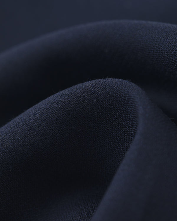 Close-up of Tropical Wool Elasticated Waist Suit Trouser in soft, dark navy fabric with smooth texture and gentle folds.