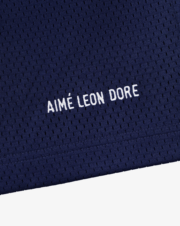 Close-up of navy blue mesh Logo Gym Short with AIMÉ LEON DORE embroidered in white capital letters.
