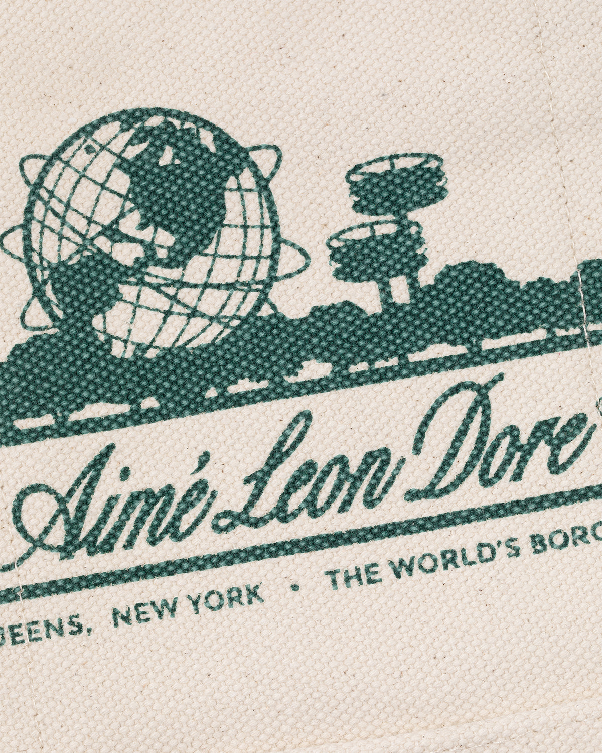 Green globe and structures graphic above "Aimé Leon Dore" with "Queens, New York, The World’s Borough" text. Mini Unisphere Tote Bag.