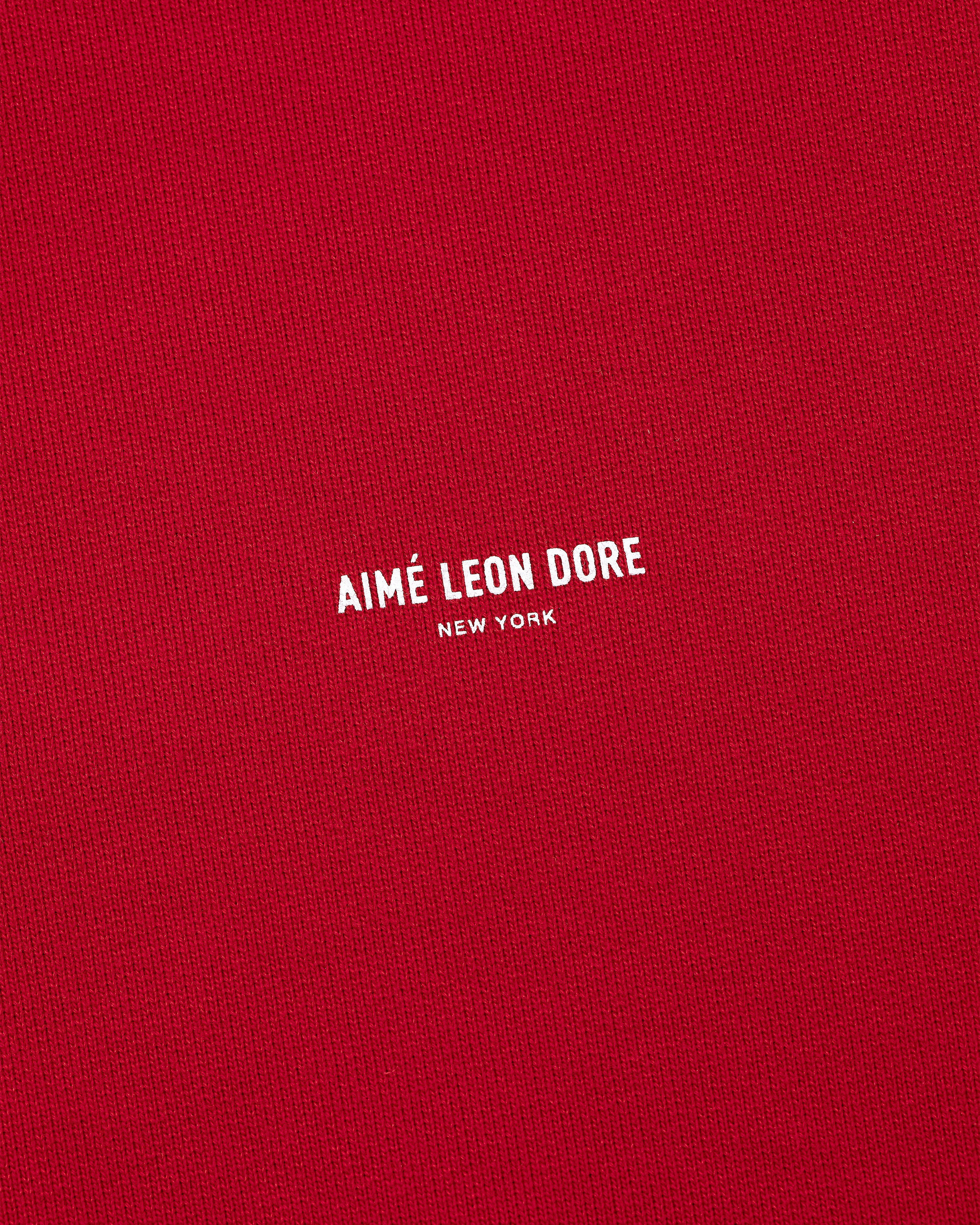 Red Micro Logo Crewneck Sweatshirt with small white AIMÉ LEON DORE NEW YORK print centered on the chest.