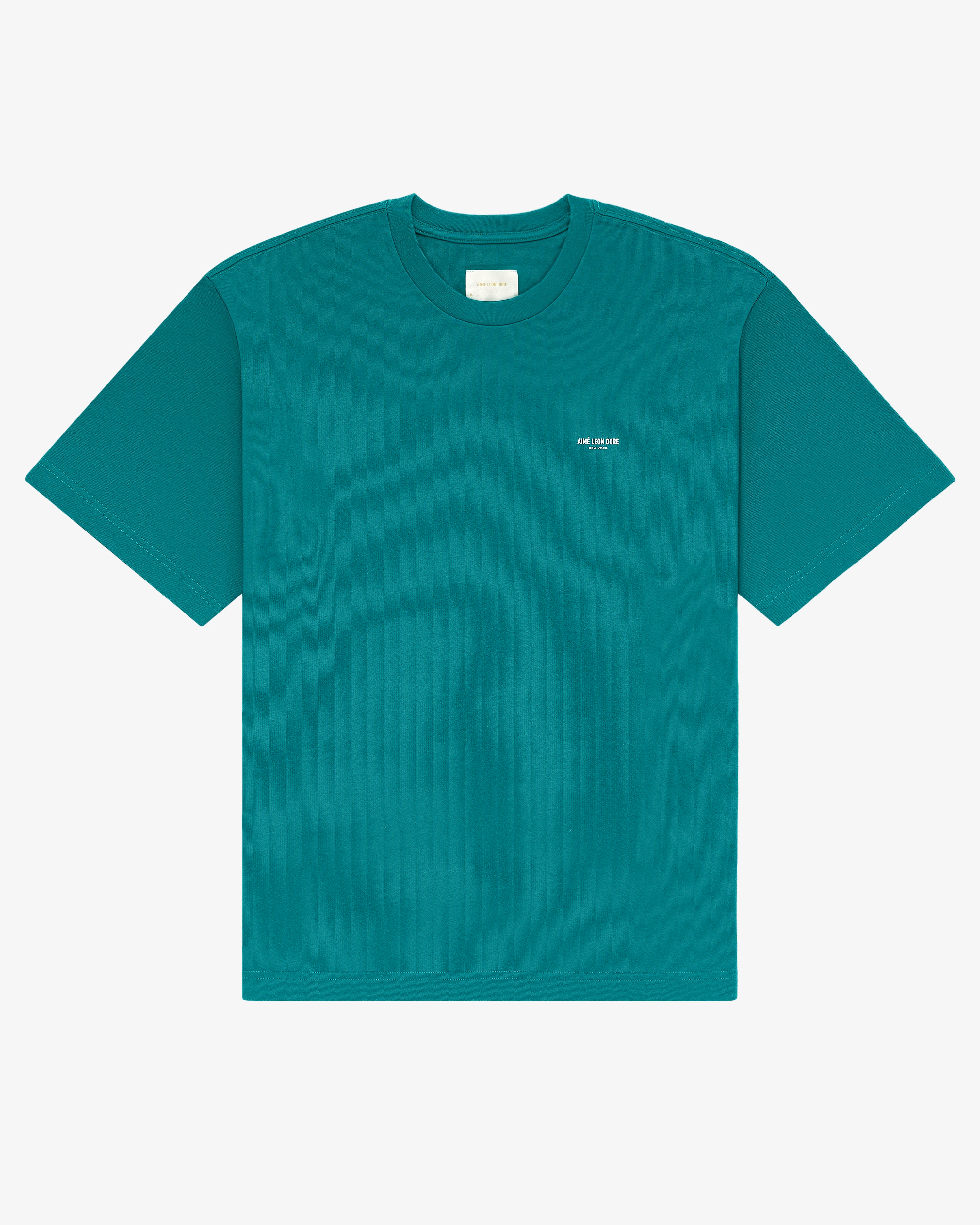 Micro Logo Tee in teal with a small white text logo on the front, shown against a plain white background.