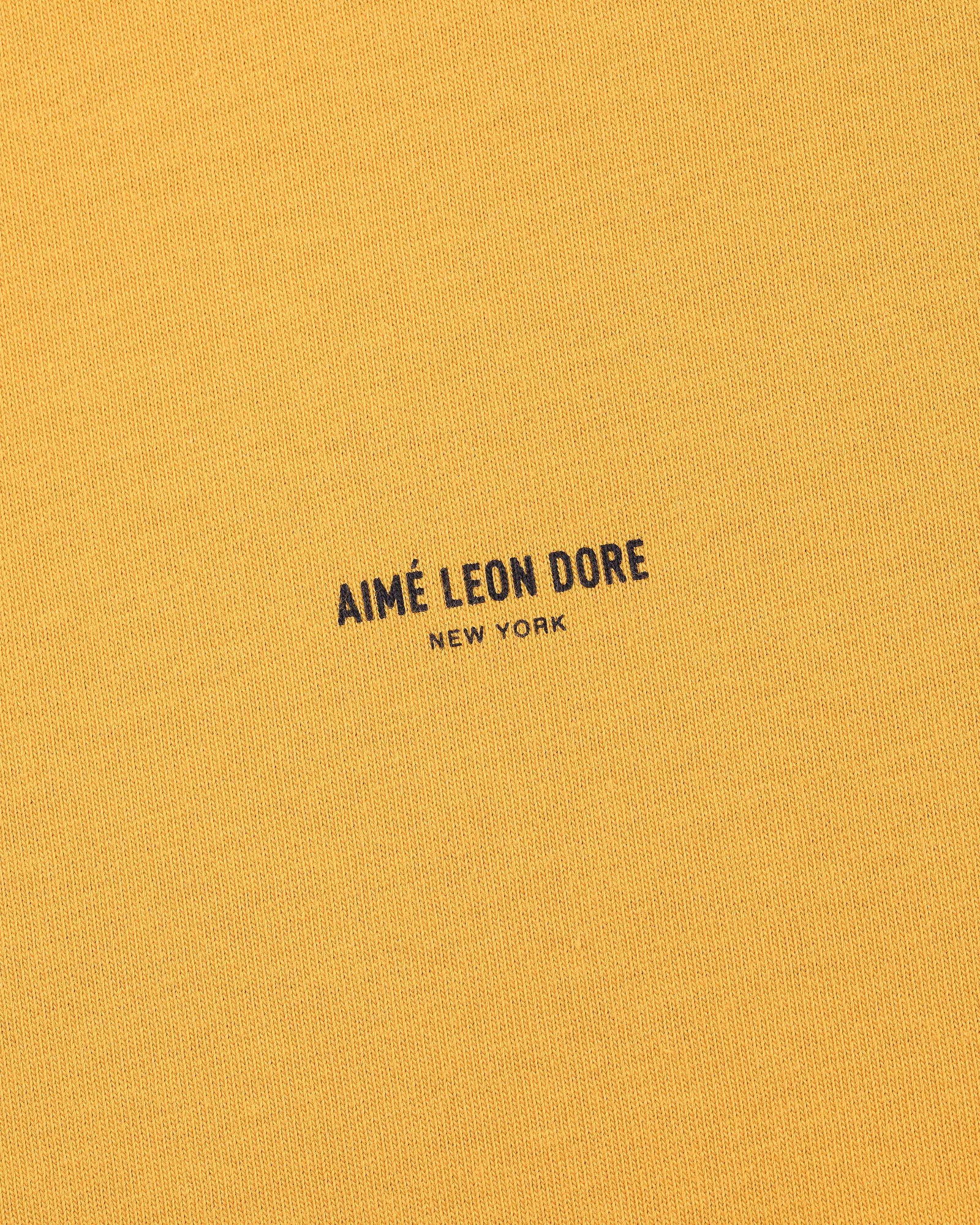 Mustard yellow Micro Logo Tee with small black AIMÉ LEON DORE NEW YORK text printed at the center.