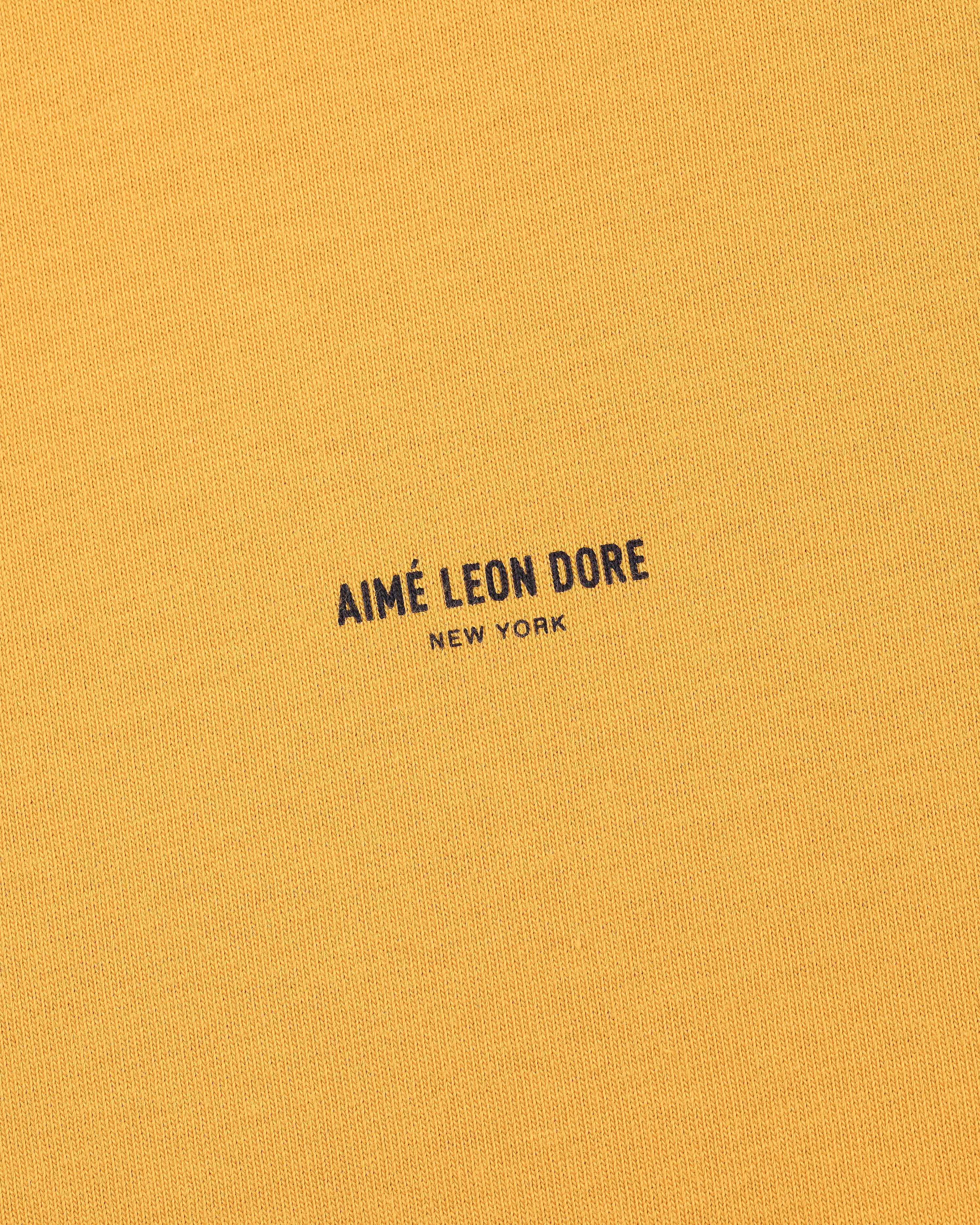 Mustard yellow Micro Logo Tee with small black AIMÉ LEON DORE NEW YORK text printed at the center.