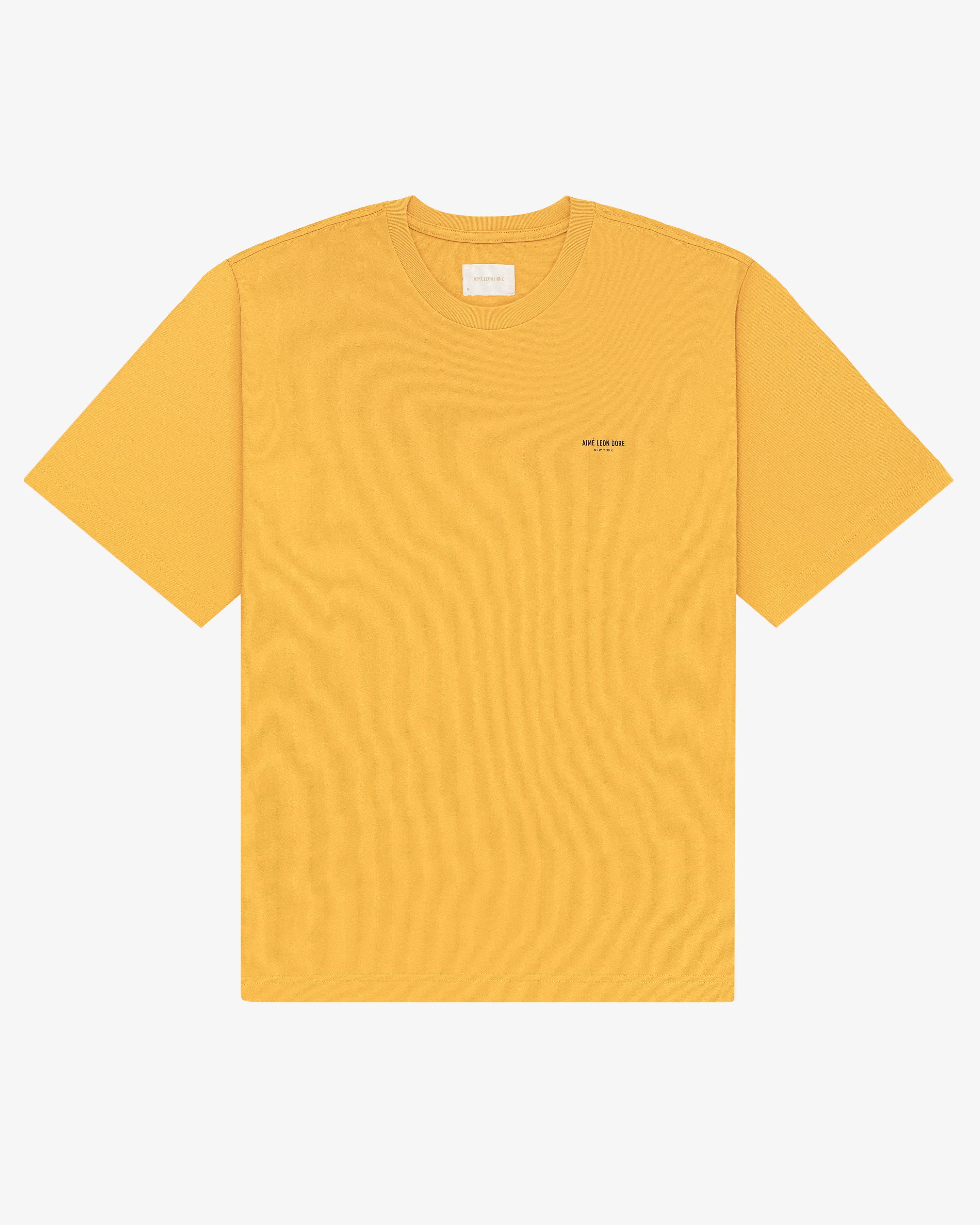 Micro Logo Tee in yellow with a subtle chest logo, short sleeves, shown on a white background.