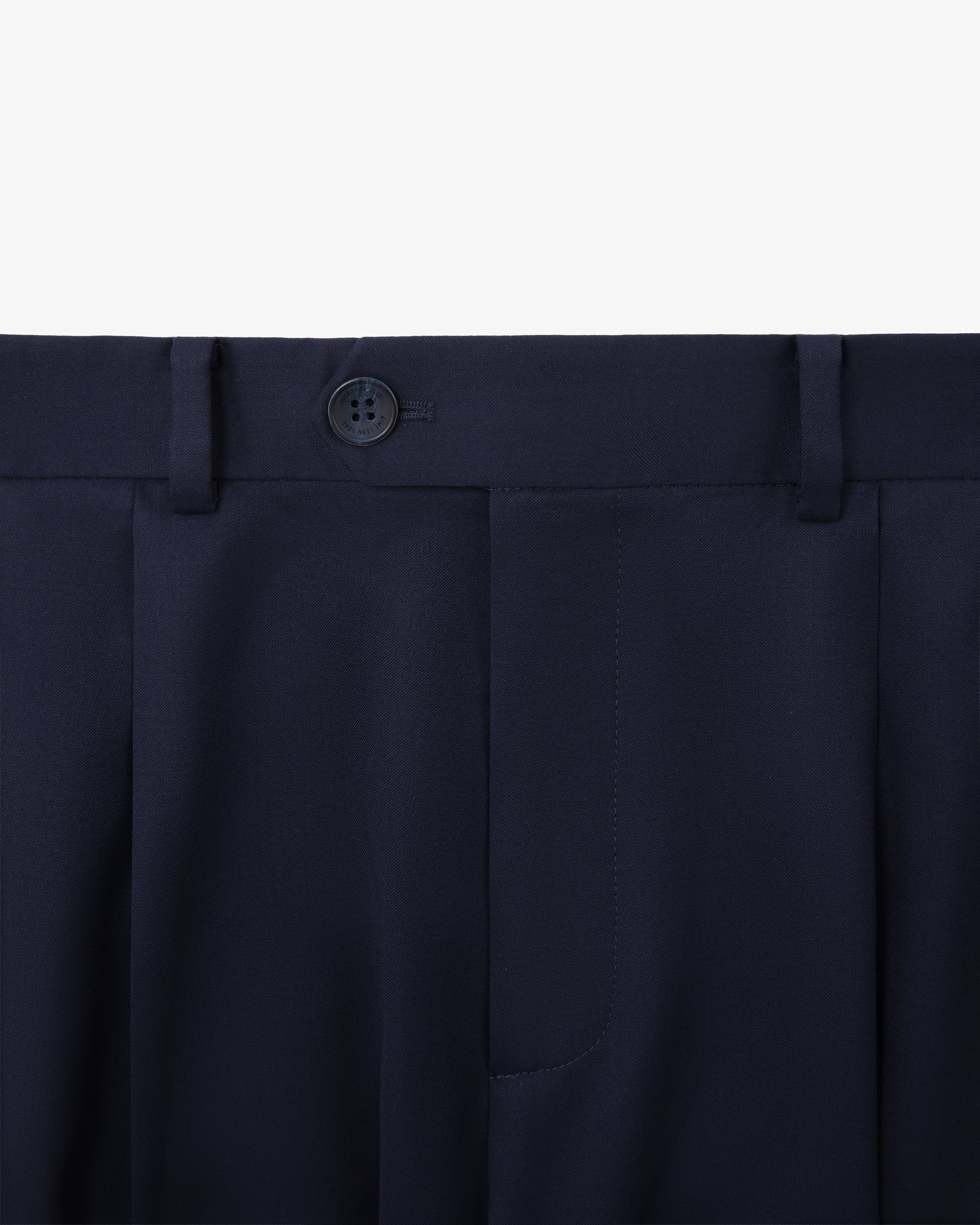 Close-up of Single-Pleated Gabardine Trouser in navy with button and belt loops on a white background.