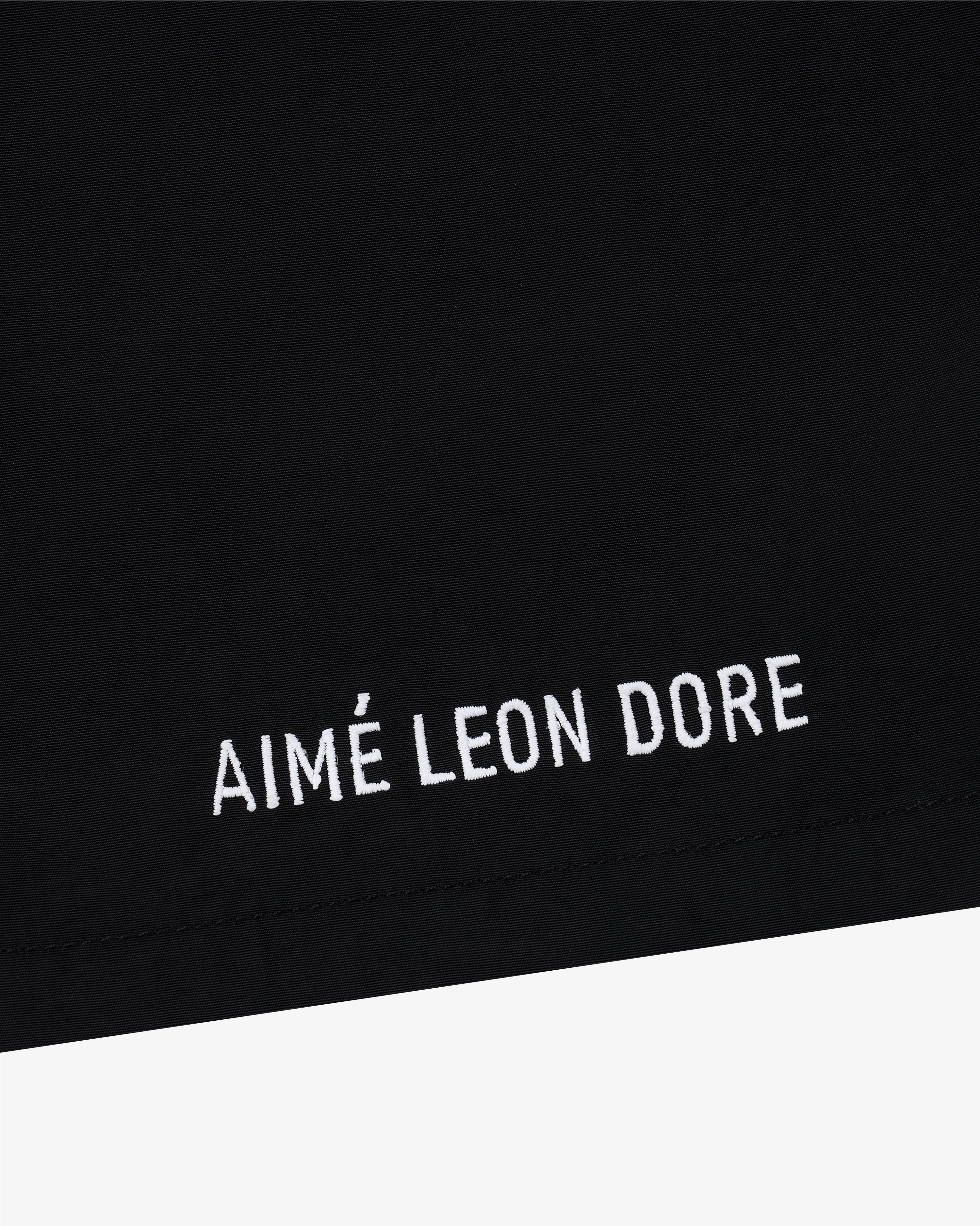 Black Core Nylon Short with white AIMÉ LEON DORE embroidery near the hem.