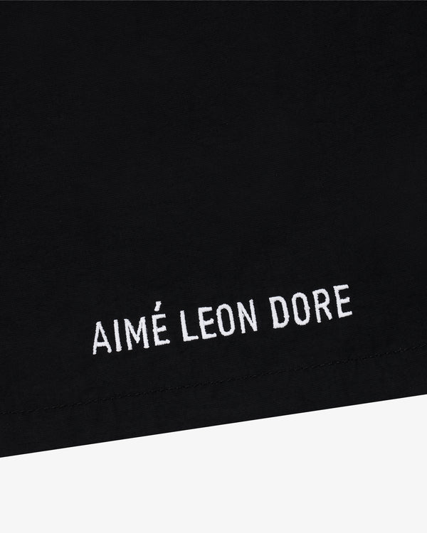 Black Core Nylon Short with white AIMÉ LEON DORE embroidery near the hem.