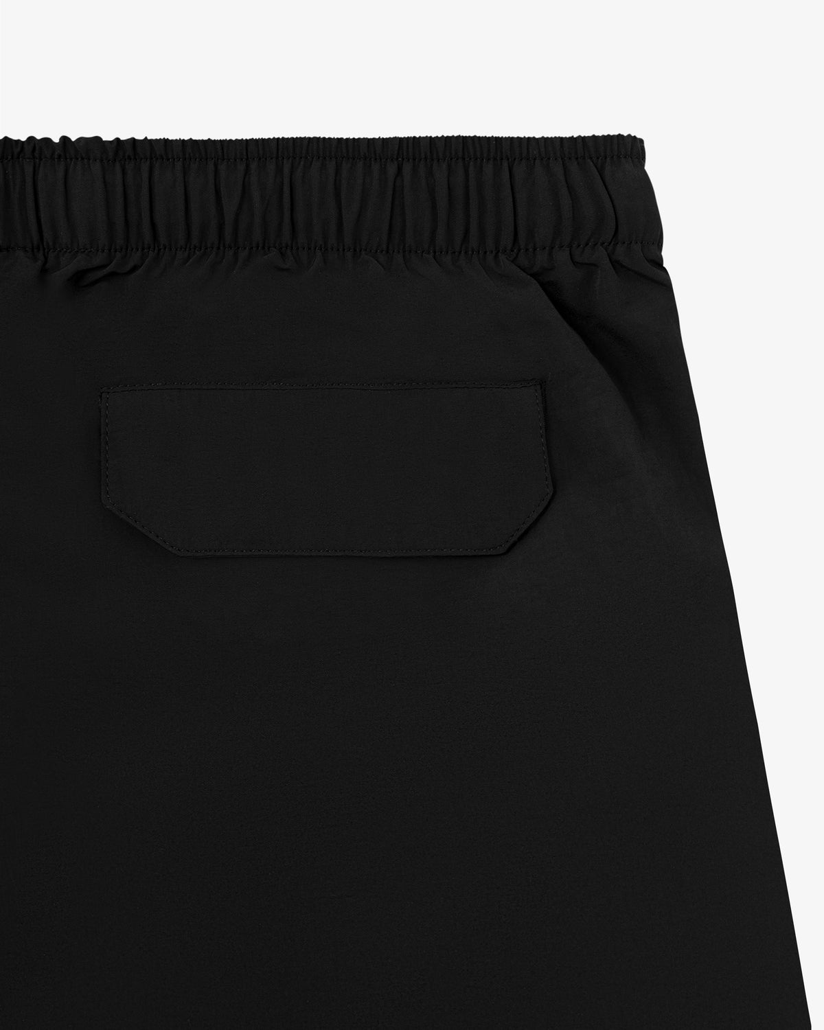 Close-up of Core Nylon Short in black featuring an elastic waistband and a single back flap pocket.