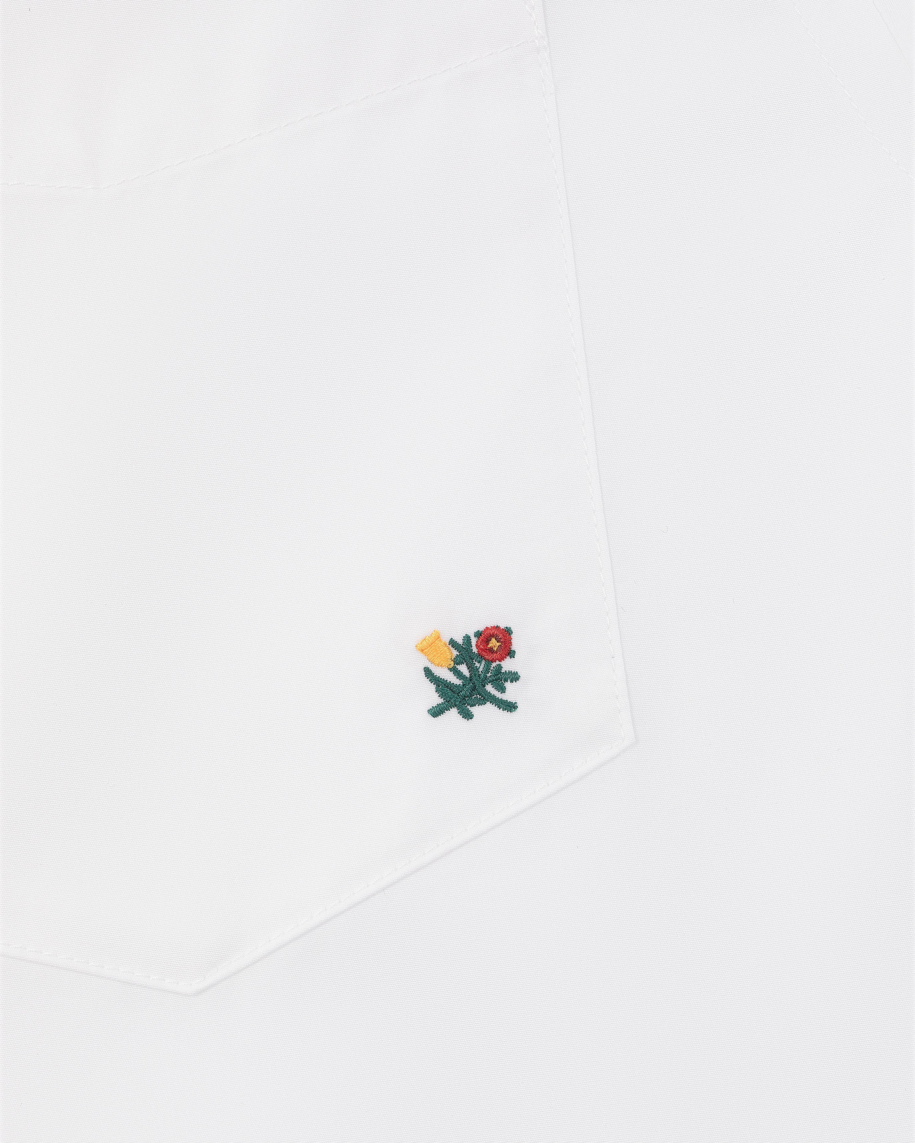 Crest Oxford Shirt with white pocket, small green flower embroidery, red center, and yellow detail near the corner.