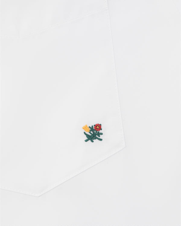 Crest Oxford Shirt with white pocket, small green flower embroidery, red center, and yellow detail near the corner.
