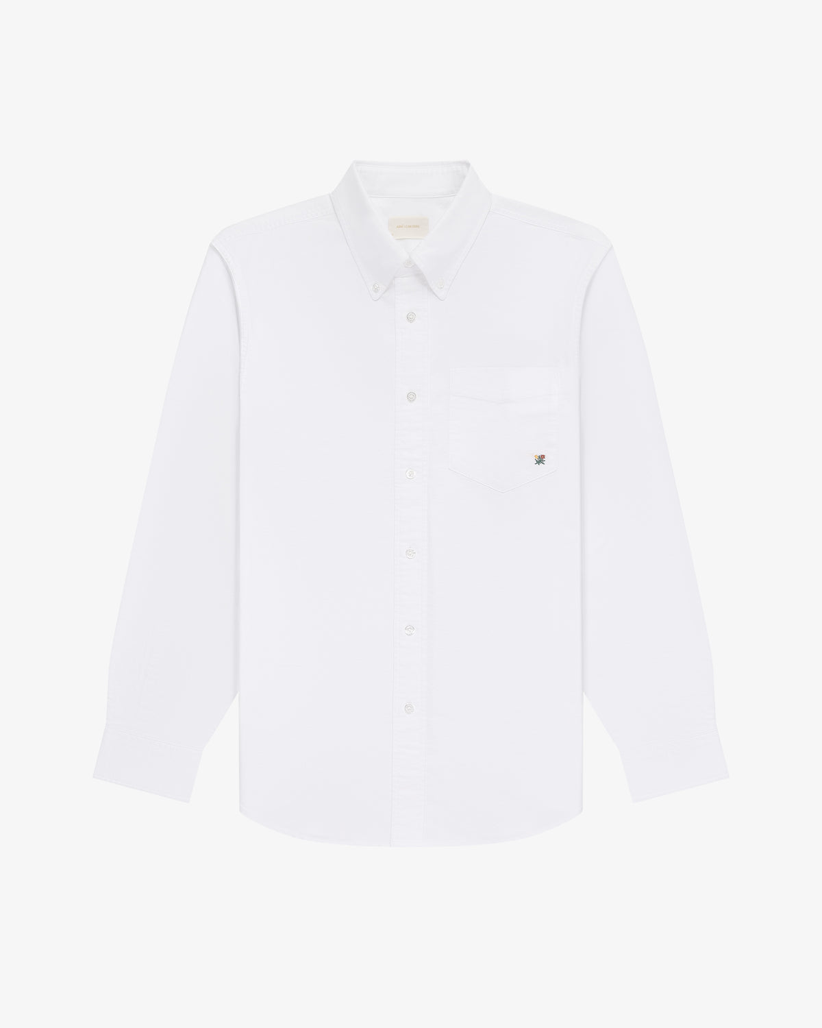 The Crest Oxford Shirt: a white, long-sleeve button-up with chest pocket, shown on a white background.