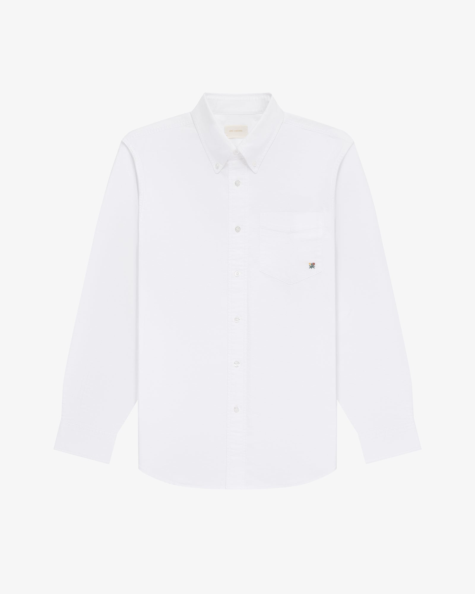 The Crest Oxford Shirt: a white, long-sleeve button-up with chest pocket, shown on a white background.