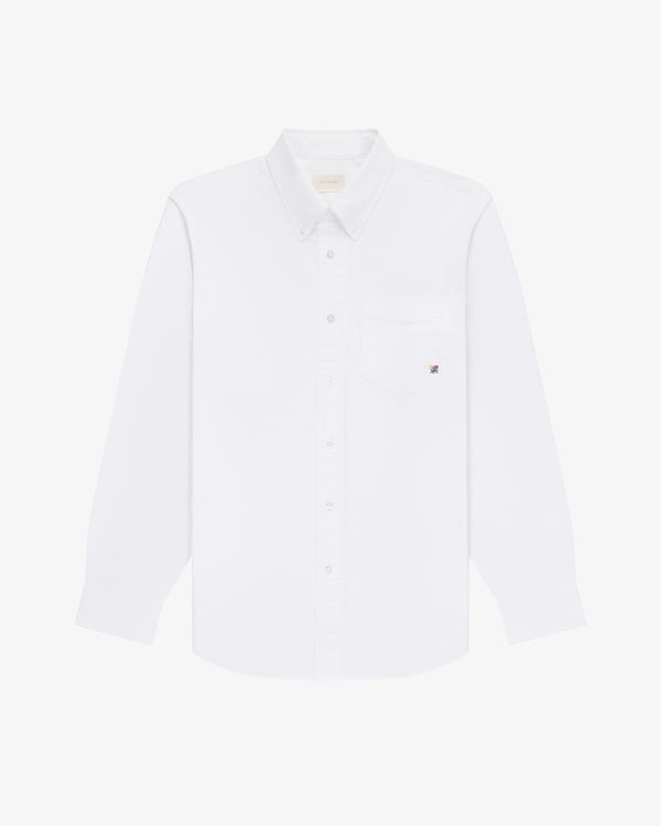 The Crest Oxford Shirt: a white, long-sleeve button-up with chest pocket, shown on a white background.