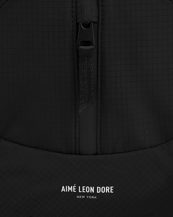 Close-up of the black Nylon Messenger Bag with a zipper and AIMÉ LEON DORE NEW YORK printed in white.