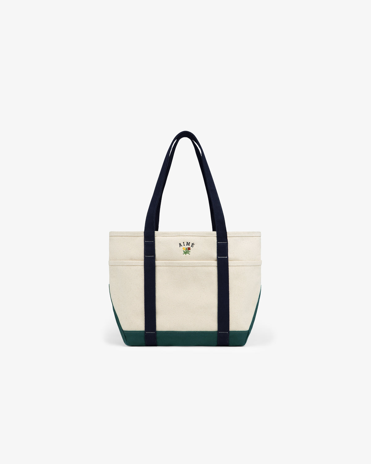 Small Crest Contrast Tote Bag: cream canvas with dark handles, green trim, and leafy logo on the front.