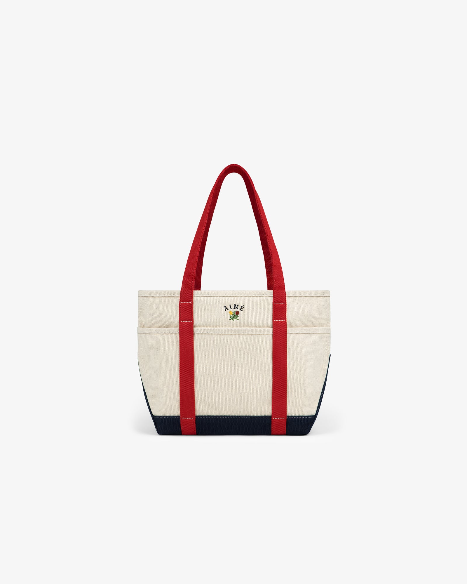 Small Crest Contrast Tote Bag with red handles, navy base, and small front logo on a white background.