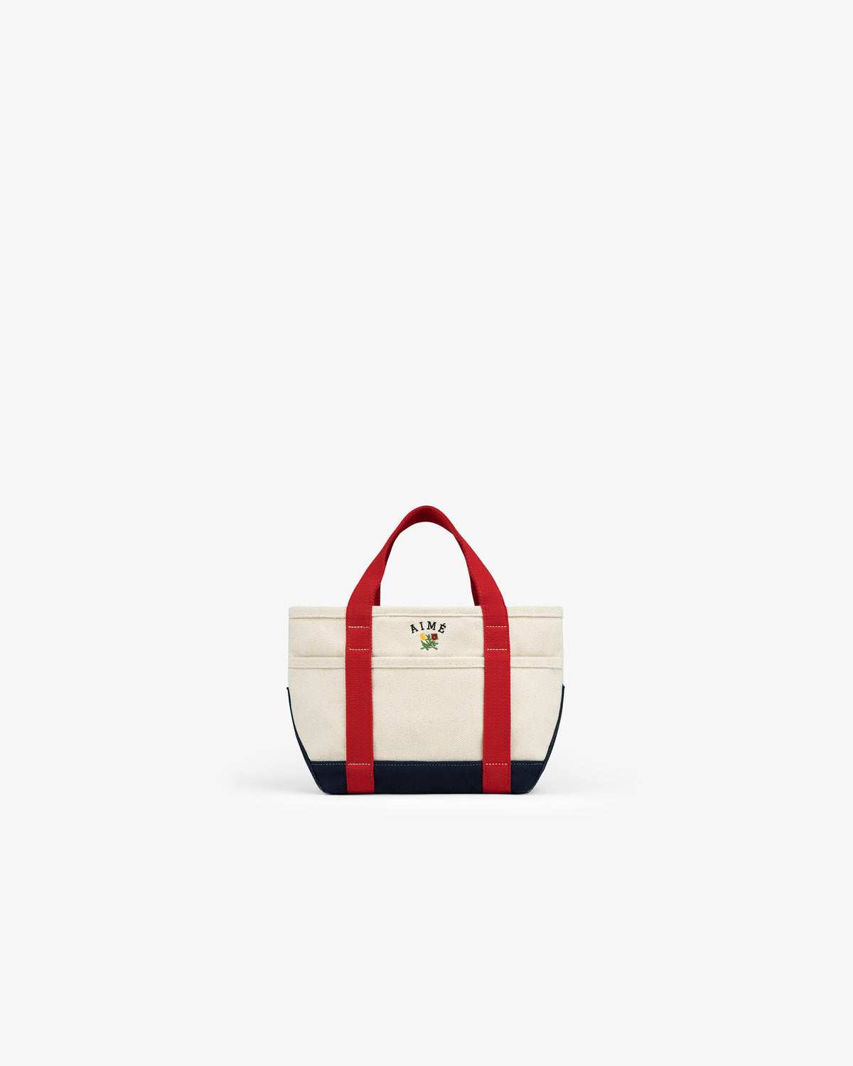 Mini Crest Contrast Tote Bag features red handles, navy base, and an embroidered “KITH” rose logo on the front.