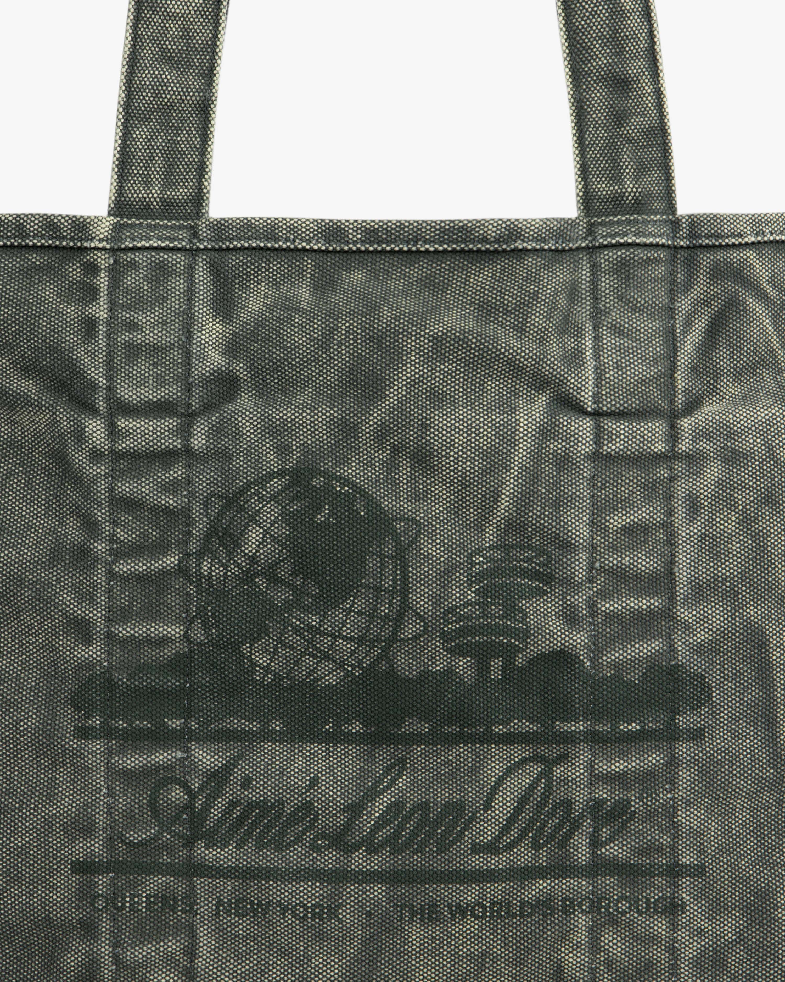 Close-up of the Sun Faded Large Unisphere Tote Bag with a printed globe, books, and "Aim-Lan Doe" on the front.