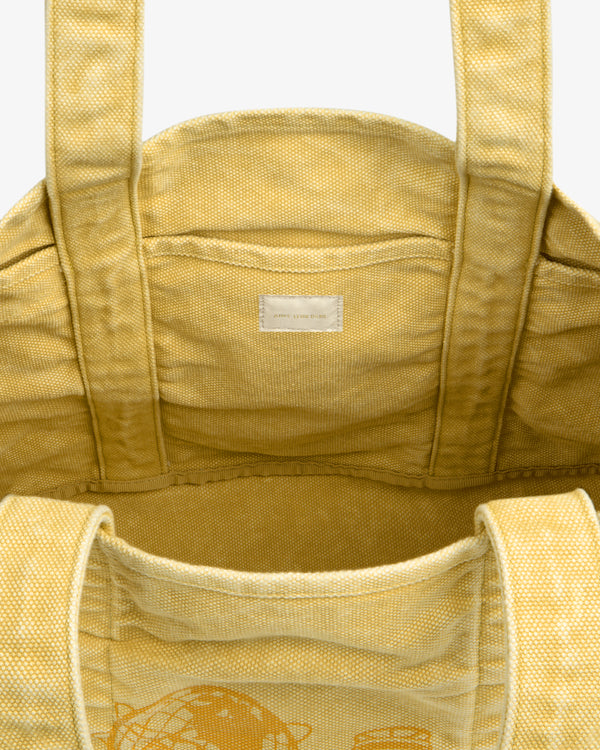 Sun Faded Large Unisphere Tote Bag in yellow canvas with sturdy handles and a small white interior label, top view.