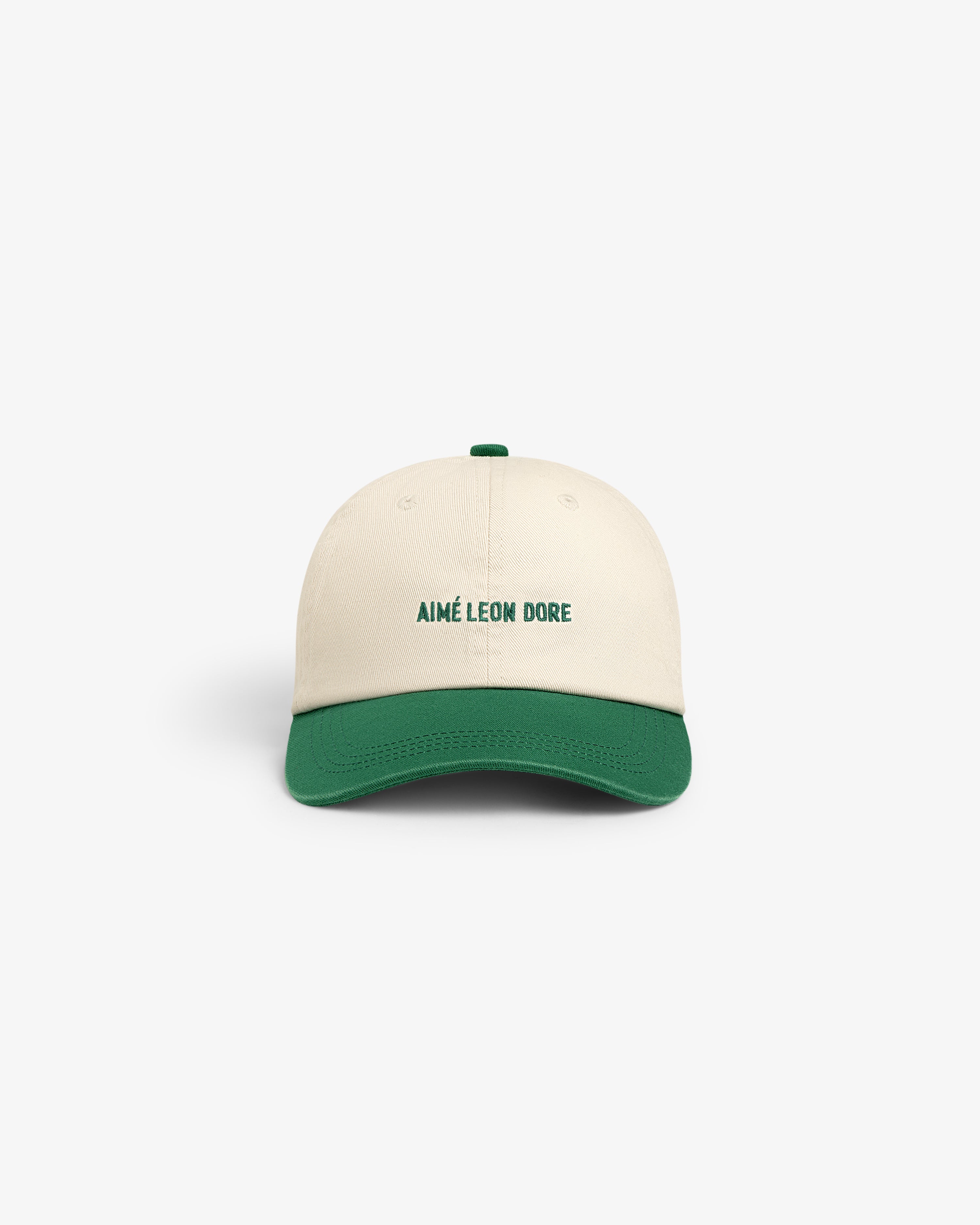 Washed Chino Hat in cream with green brim and AIMÉ LEON DORE text embroidered on the front, shown front-facing.
