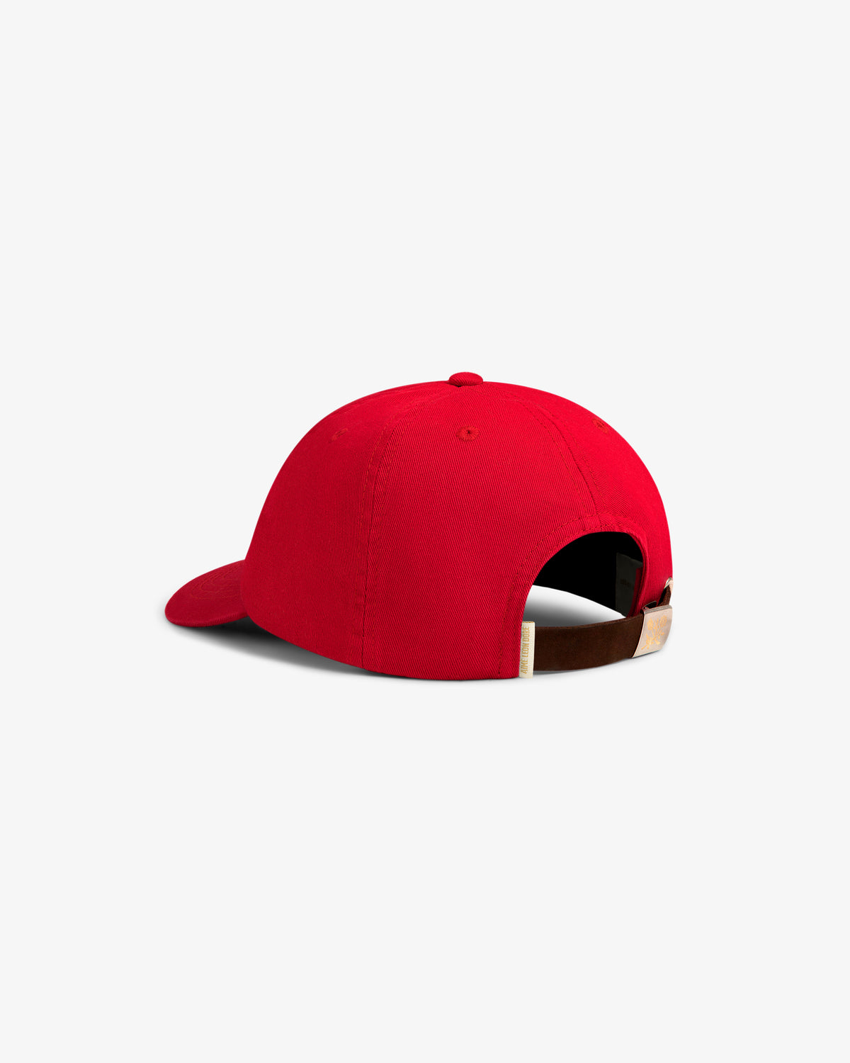 The Crest Logo Hat is a red baseball cap with an adjustable brown strap and buckle, shown from the back on white.