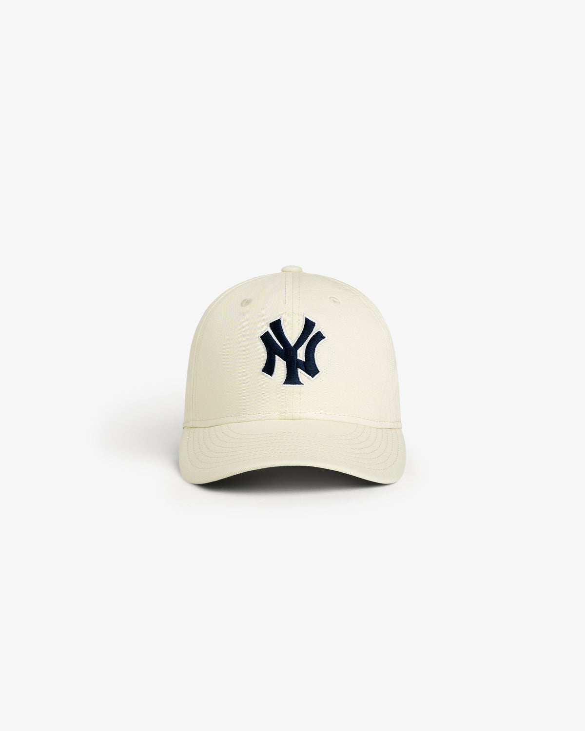 The ALD / New Era Yankees Retro Fit Hat is cream-colored with a black New York Yankees logo on the front.