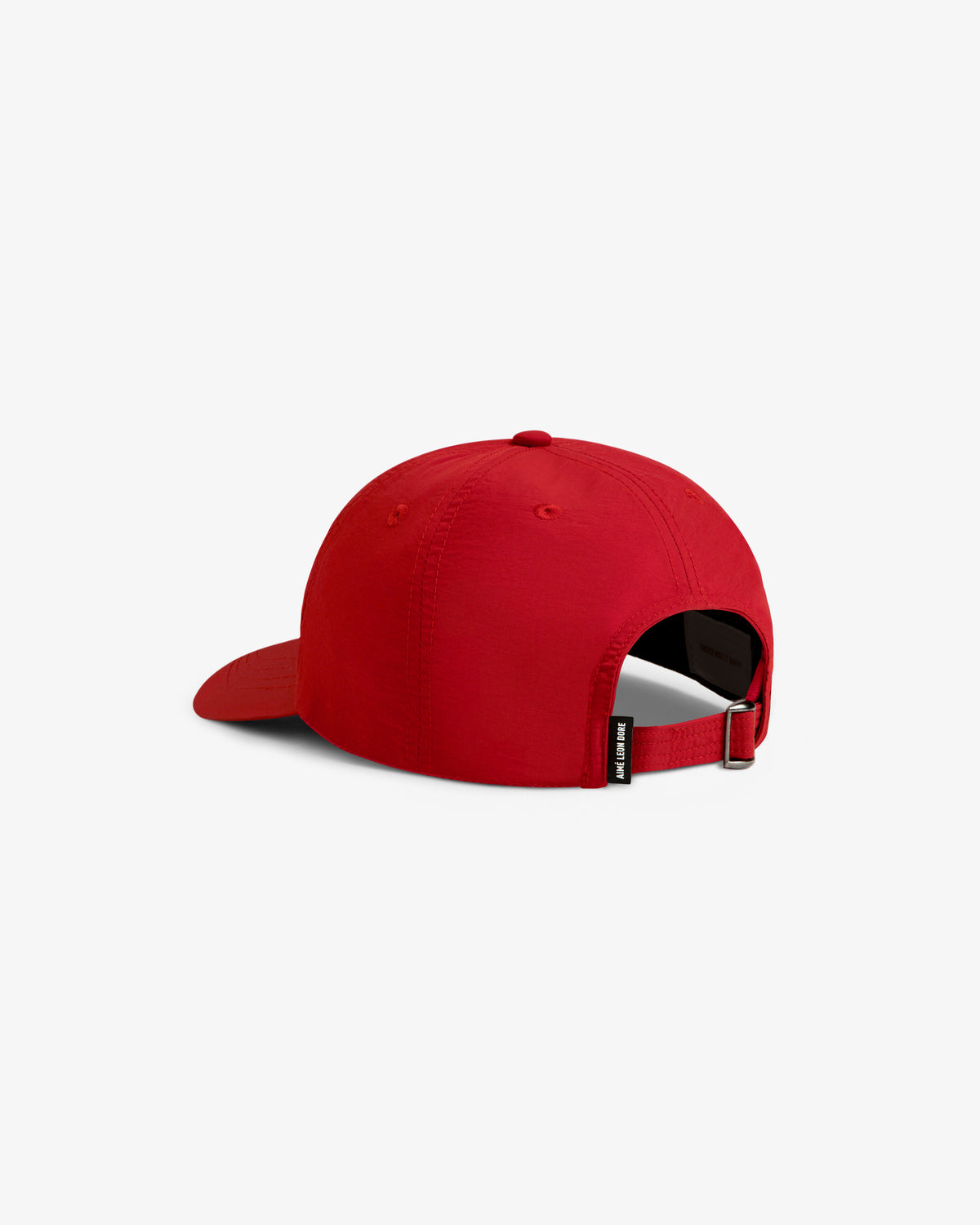 A Nylon Crusher Hat in red, shown from the back with an adjustable strap and a small black side tag.