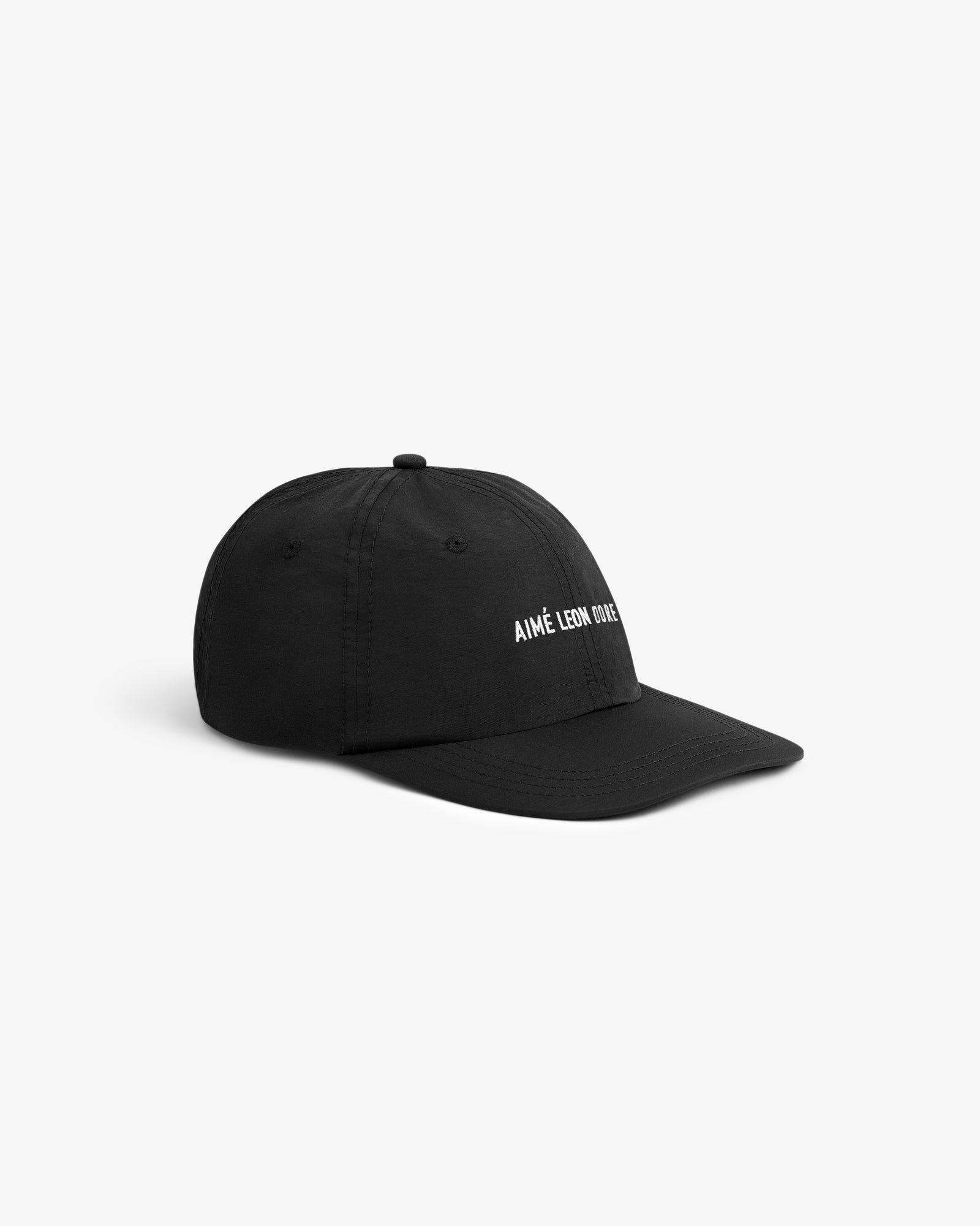 A black Nylon Sport Hat with AIMÉ LEON DORE in white embroidery, displayed on a plain white background.