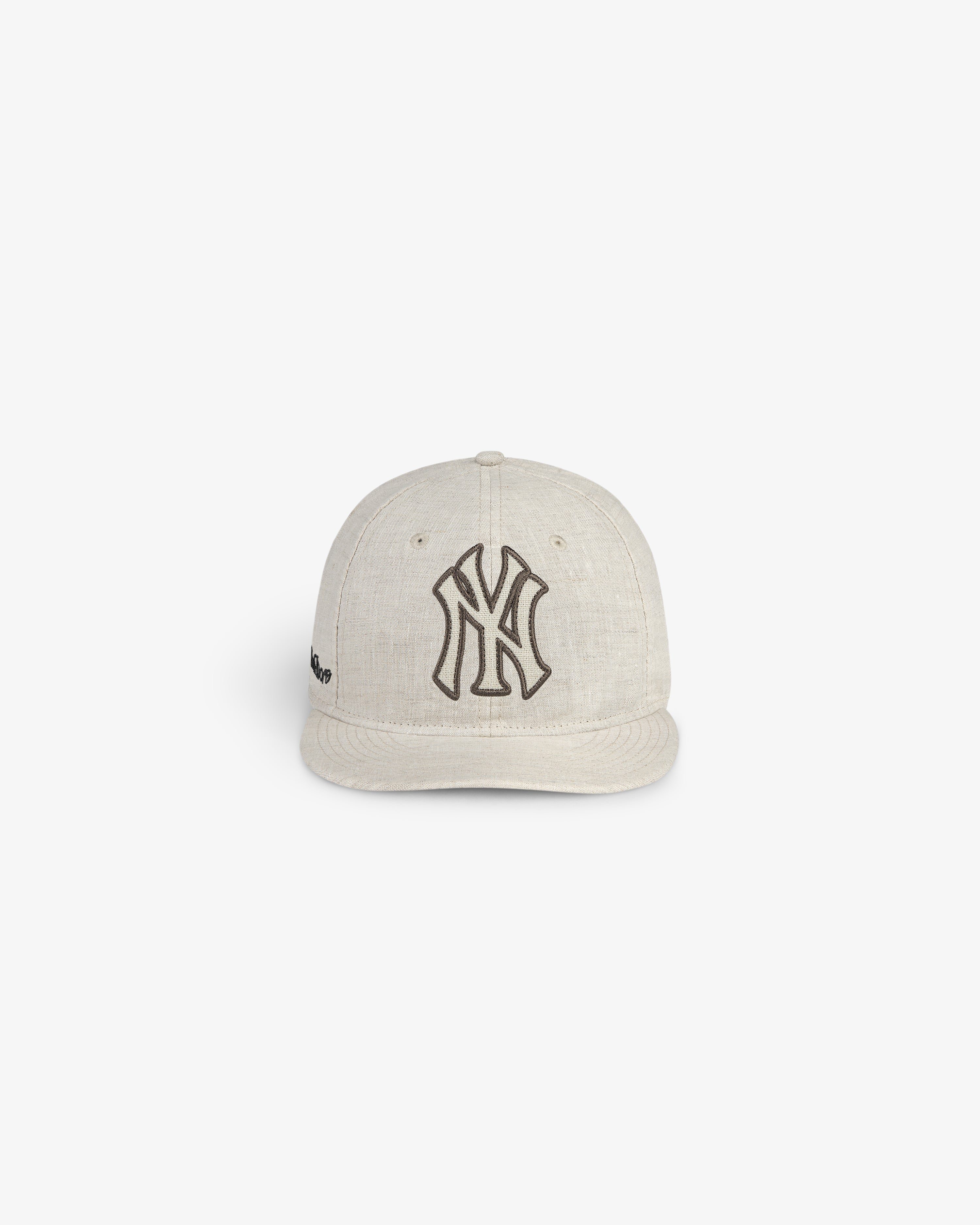 ALD / New York Yankees Retro Fit Hat in beige with a black logo, shown on a plain white background.