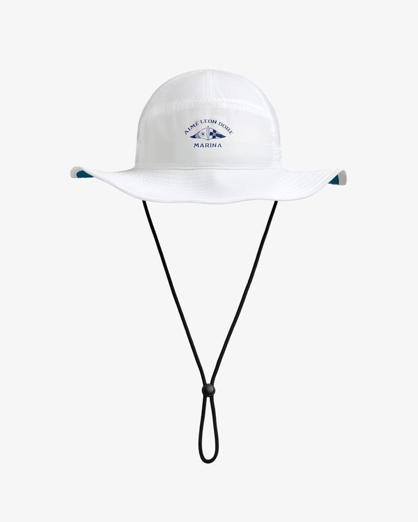 Marina Boonie Bucket Hat: white, wide-brim with chin strap and blue Marina logo on front, shown on plain background.