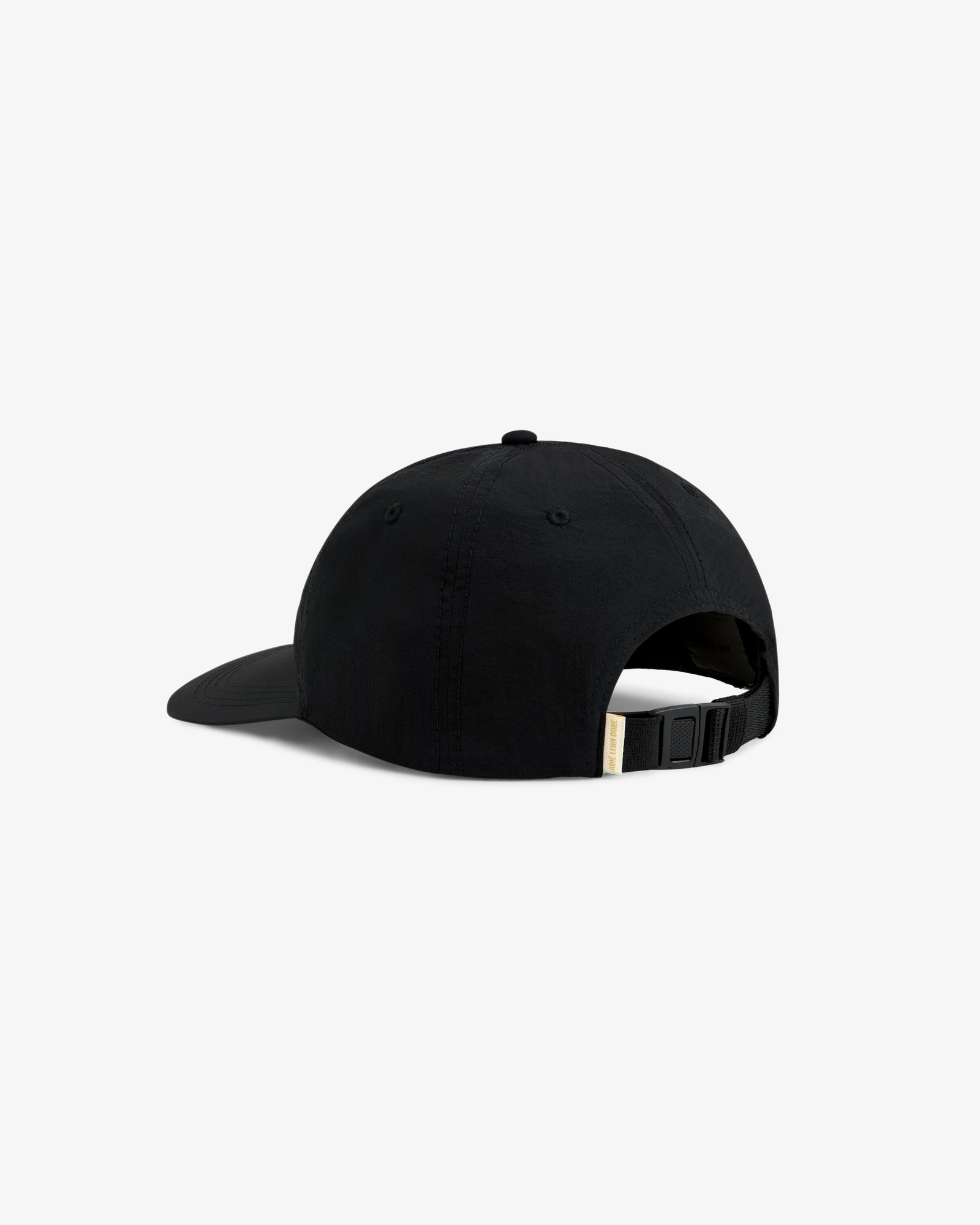 The Krylon Label Hat is a black cap with a curved brim, shown from the back, and features an adjustable strap.