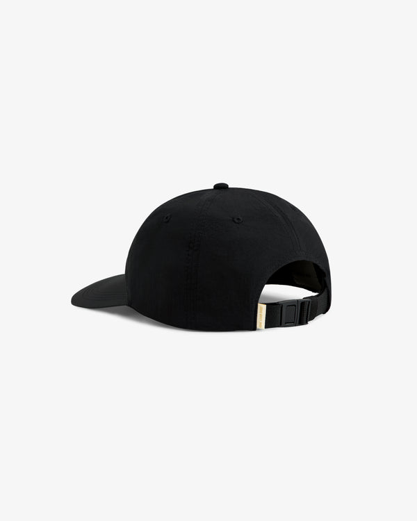 The Krylon Label Hat is a black cap with a curved brim, shown from the back, and features an adjustable strap.