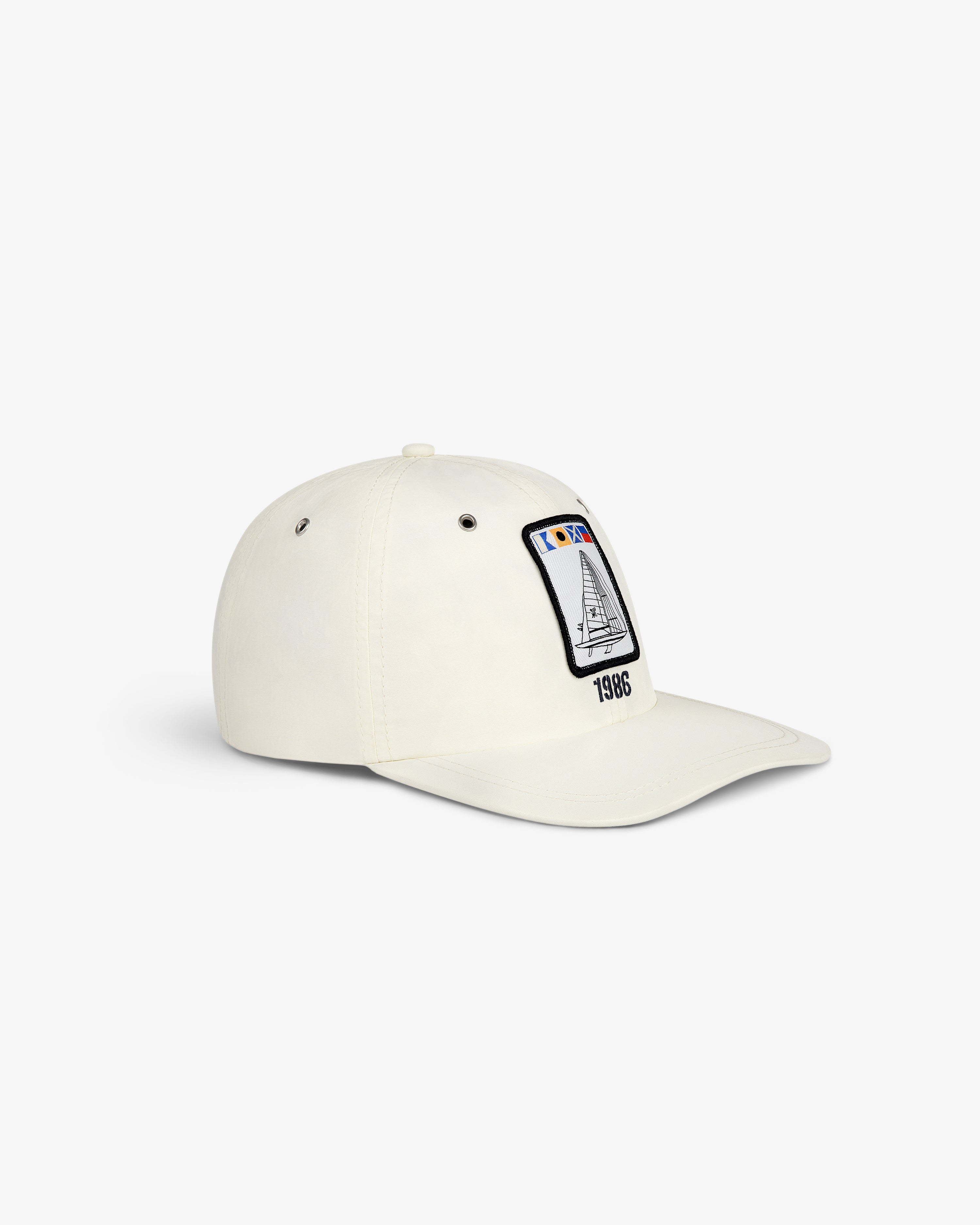 Nylon Deck Hat in off-white with a front panel patch showing a sailboat and 1986 embroidery.