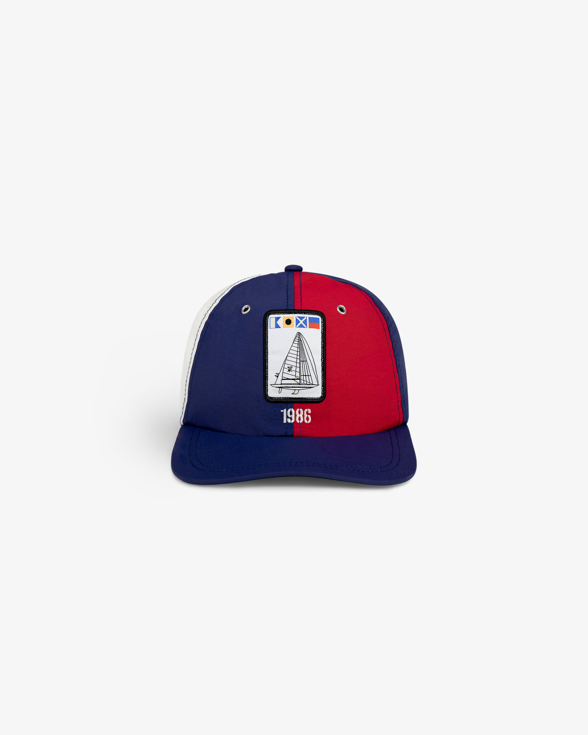 Nylon Deck Hat with red, blue, and white panels, sailboat patch, and 1986 embroidered on the front.