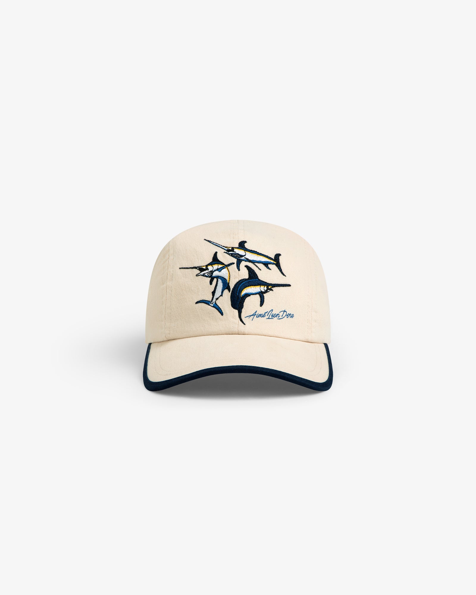 Souvenir Fishing Hat: Beige baseball cap with marlin embroidery and dark blue brim trim, shown on white background.