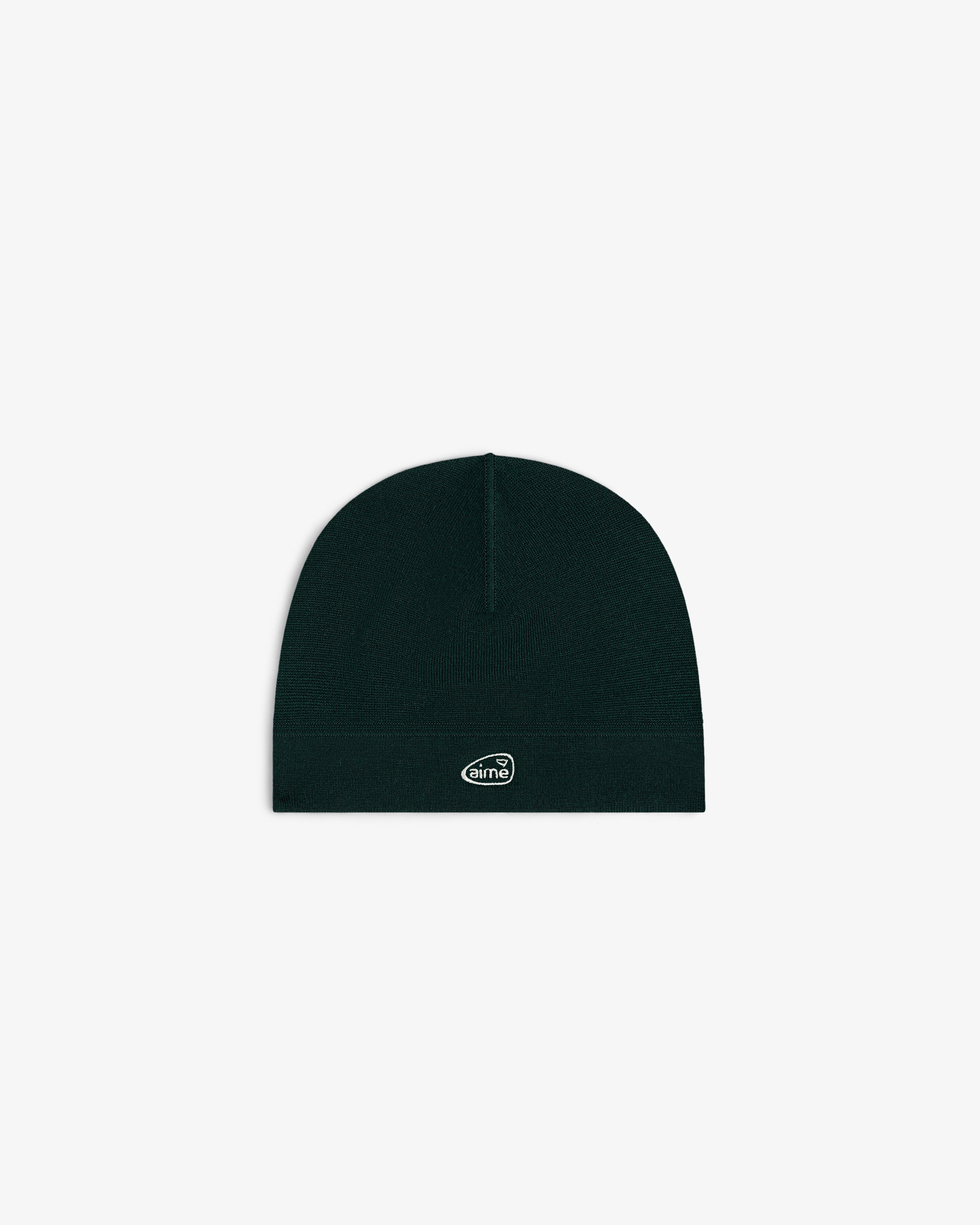 ALD Golf Skull Cap—black knit beanie with small white oval logo patch, shown on plain white background.