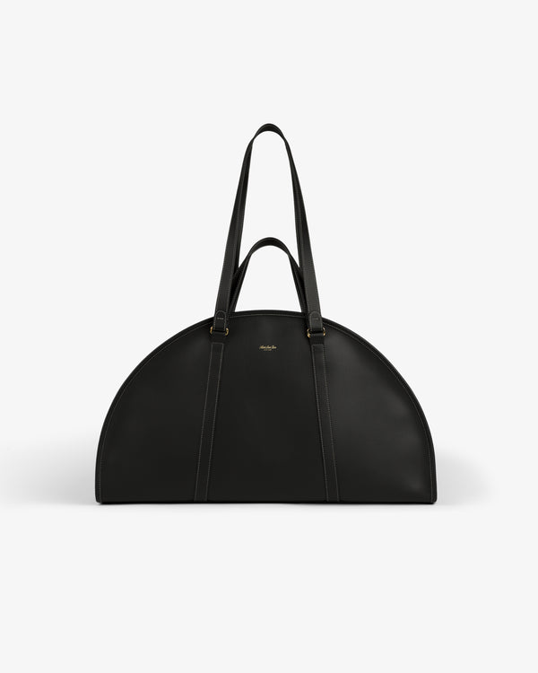 A black Full Grain Leather Weekender Bag with two handles, semi-circular shape, on a plain white background.