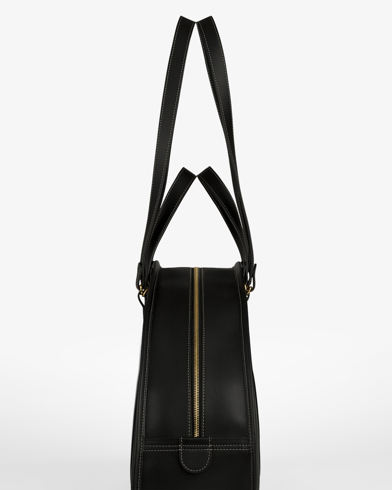 Full Grain Leather Weekender Bag in black, with gold zipper and double handles, shown side view on white background.