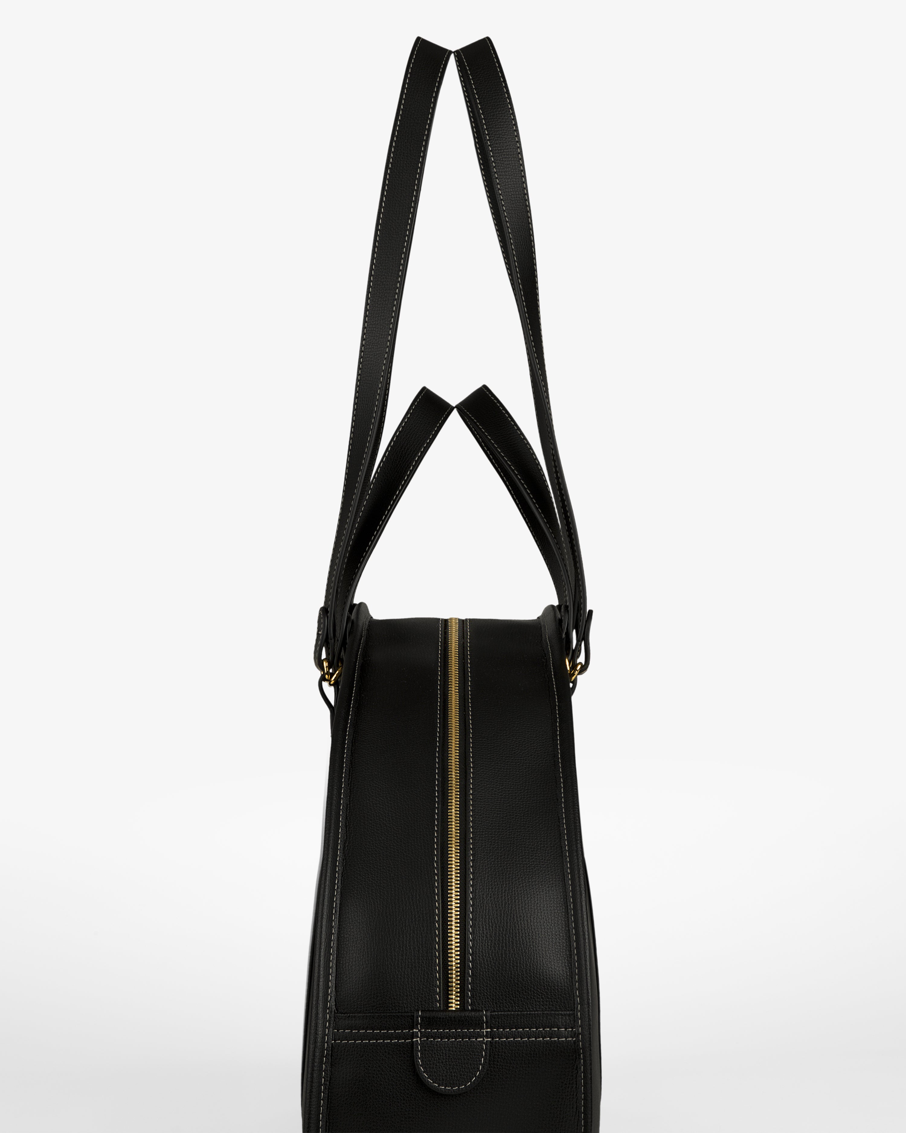 Full Grain Leather Weekender Bag in black, with gold zipper and double handles, shown side view on white background.