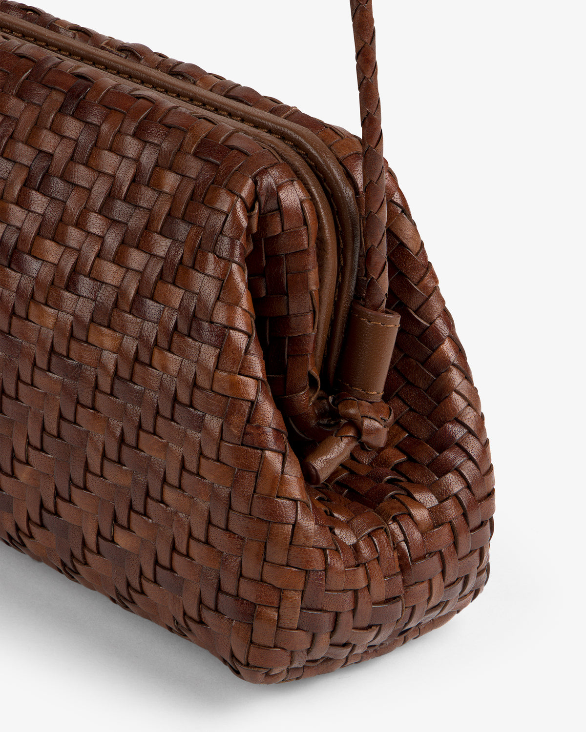 Close-up of the Woven Leather Shoulder Bag in brown, featuring a zipper and braided handle, on a white background.