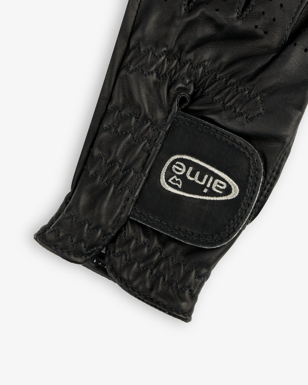 Close-up of the ALD / FootJoy StaSof Heritage Glove (Left) in black leather with visible stitching and aimé velcro strap.